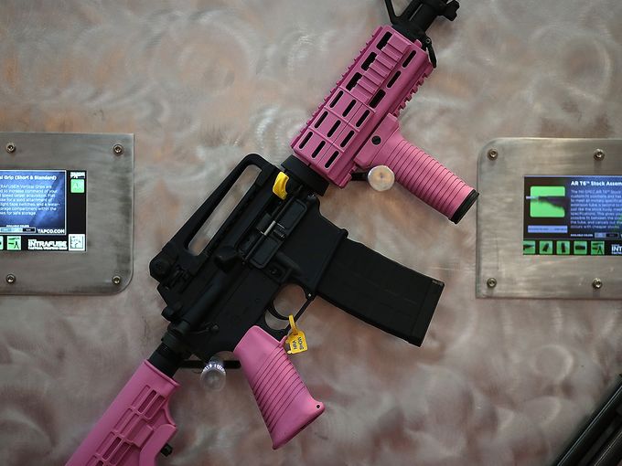 An AR-15 rifle is accessorized with a pink hand guard, vertical grip, pistol grip and stock assembly. Justin Sullivan- Getty images