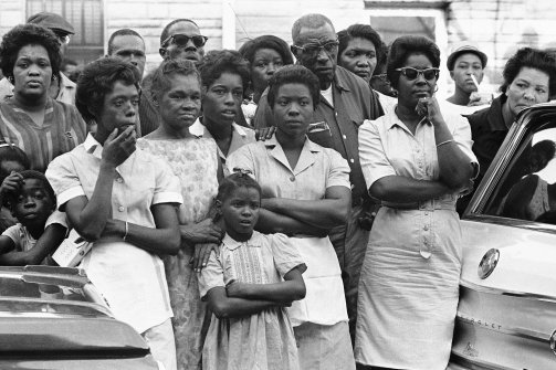Unidentified mourners, who overflowed the church, stand across the street during funeral services for 14-year-old Carol Robertson, Sept. 17, 1963, Birmingham, Ala. The girl was one of four young African Americans killed in a bomb blast the previous Sunday. (AP)/Via, The Daily Beast