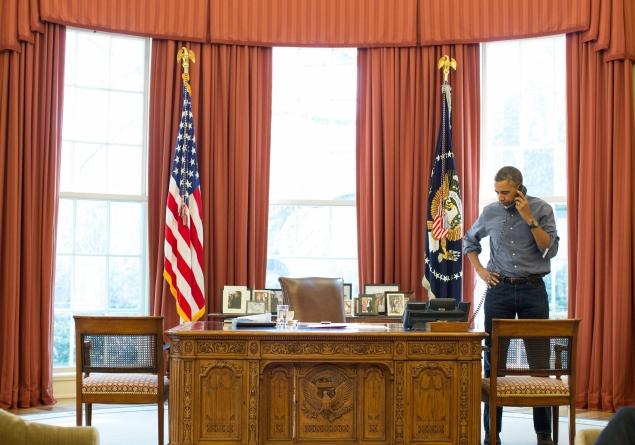 President Obama talking on the phone in the Oval Office with Russian President Vladimir Putin about the situation in Ukraine on Saturday. Photo by Pete Souza