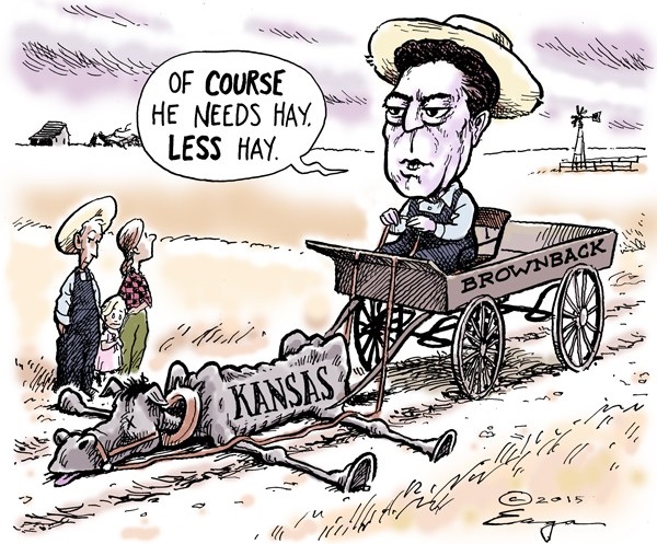 Sam Brownback in wagon labeled 